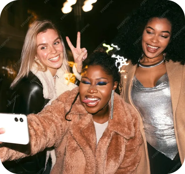 Three friends taking a selfie at a night event