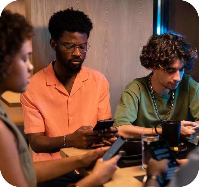 Two attendees chatting over their phones